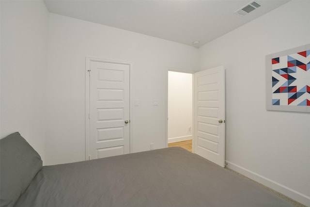 unfurnished bedroom with baseboards and visible vents