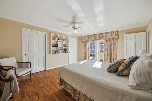 bedroom with access to exterior, wood finished floors, french doors, crown molding, and ceiling fan