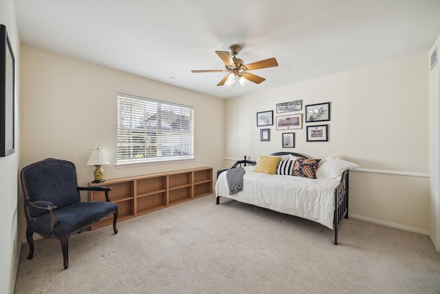 carpeted bedroom featuring baseboards and a ceiling fan