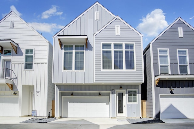 view of front of house featuring board and batten siding, an attached garage, and driveway