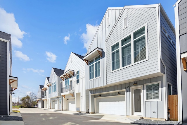 view of front of property featuring a residential view, board and batten siding, and a garage