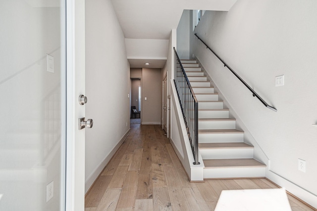 stairway with baseboards and wood-type flooring