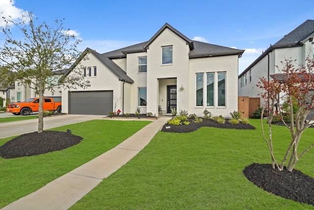 modern farmhouse style home featuring brick siding, concrete driveway, a front lawn, and a shingled roof