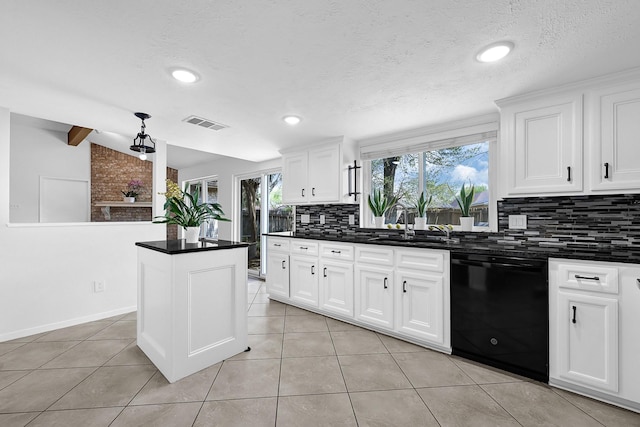 kitchen with visible vents, lofted ceiling, decorative backsplash, black dishwasher, and dark countertops