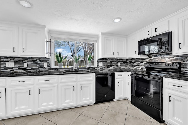 kitchen with light tile patterned floors, a sink, black appliances, white cabinetry, and backsplash