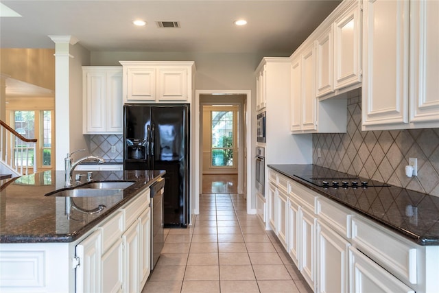 kitchen with visible vents, black appliances, light tile patterned floors, white cabinetry, and a sink