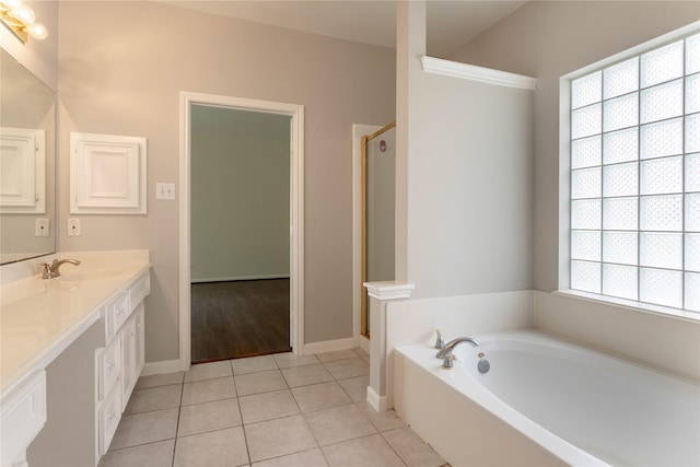 bathroom with tile patterned flooring, a stall shower, vanity, and a garden tub