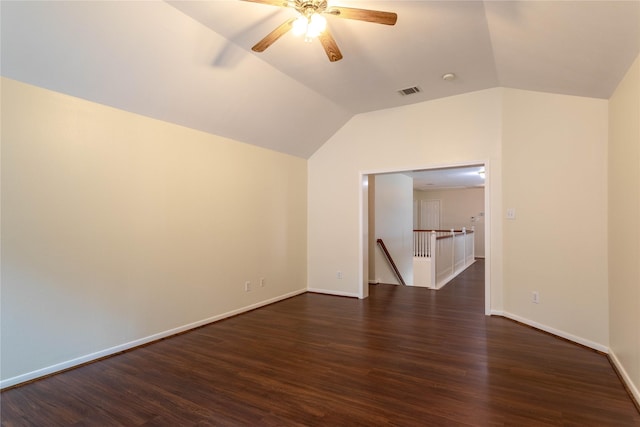 spare room featuring visible vents, baseboards, dark wood finished floors, lofted ceiling, and ceiling fan