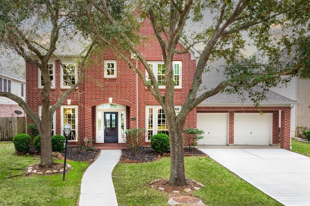 view of front facade featuring concrete driveway, an attached garage, and brick siding