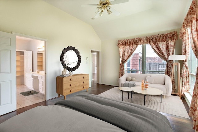 bedroom with connected bathroom, high vaulted ceiling, ceiling fan, and wood finished floors