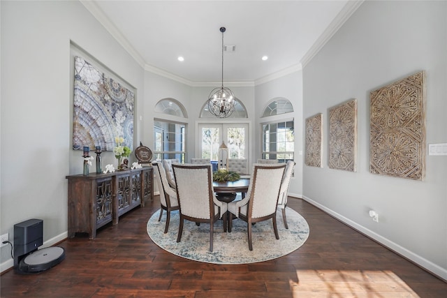 dining area featuring a notable chandelier, wood finished floors, baseboards, and ornamental molding