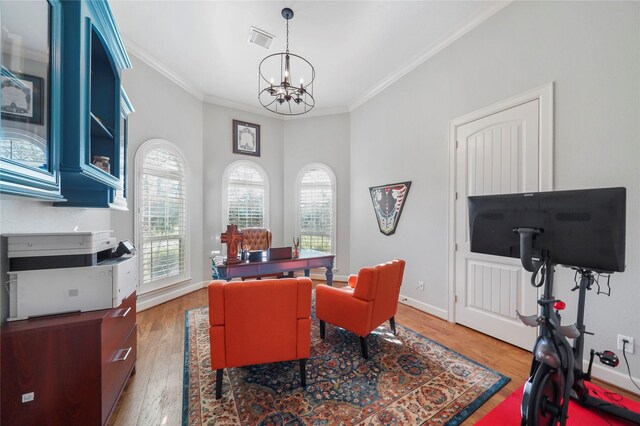 office space featuring visible vents, ornamental molding, light wood-style floors, an inviting chandelier, and baseboards