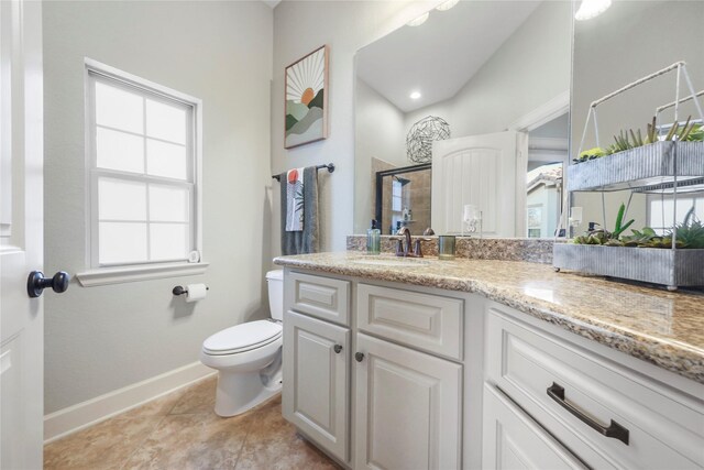 bathroom featuring vanity, baseboards, tile patterned flooring, a shower stall, and toilet