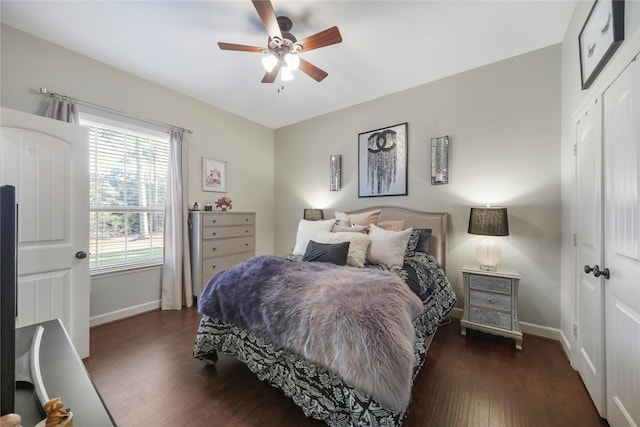 bedroom featuring ceiling fan, a closet, baseboards, and wood finished floors