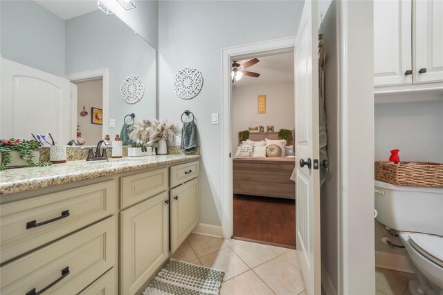 ensuite bathroom featuring toilet, ensuite bathroom, tile patterned flooring, ceiling fan, and vanity