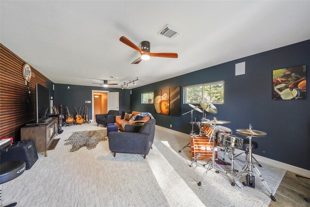 living area with visible vents, baseboards, and an accent wall