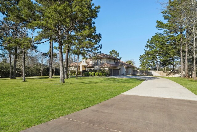 surrounding community with a yard, fence, and driveway