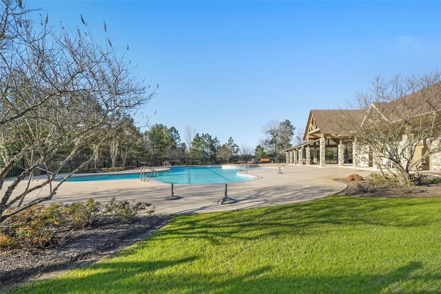 community pool featuring a yard and a patio