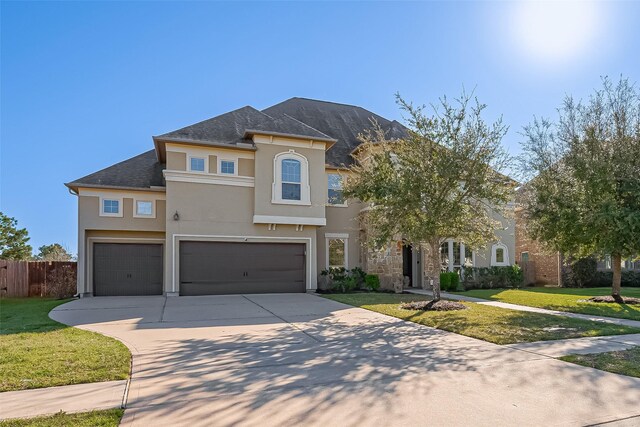 10018 Durango Path Ln, Cypress, TX 77433 - view of front of home featuring a front lawn, an attached garage, concrete driveway, and stucco siding