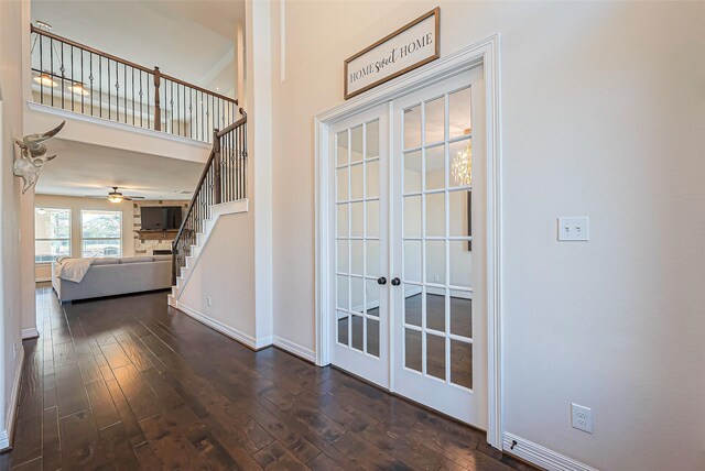 10018 Durango Path Ln, Cypress, TX 77433 - entrance foyer featuring dark wood-type flooring, baseboards, stairs, french doors, and a towering ceiling