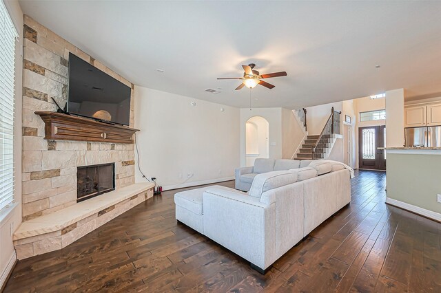 10018 Durango Path Ln, Cypress, TX 77433 - living area featuring a stone fireplace, dark wood-type flooring, stairway, and visible vents