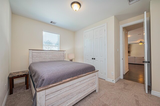 10018 Durango Path Ln, Cypress, TX 77433 - bedroom with visible vents, baseboards, a closet, and light carpet