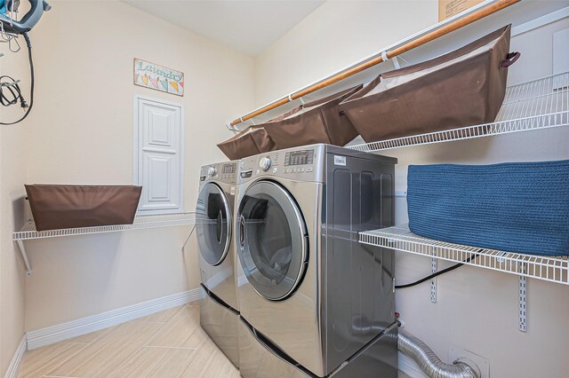 10018 Durango Path Ln, Cypress, TX 77433 - laundry room with laundry area, washer and dryer, and baseboards