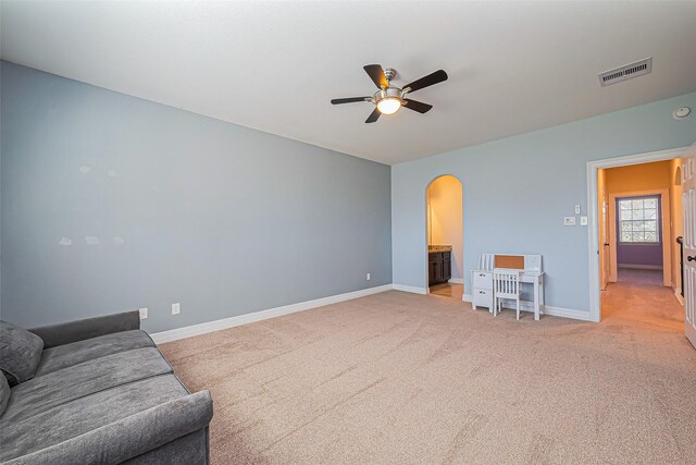 10018 Durango Path Ln, Cypress, TX 77433 - living area with visible vents, baseboards, ceiling fan, light carpet, and arched walkways