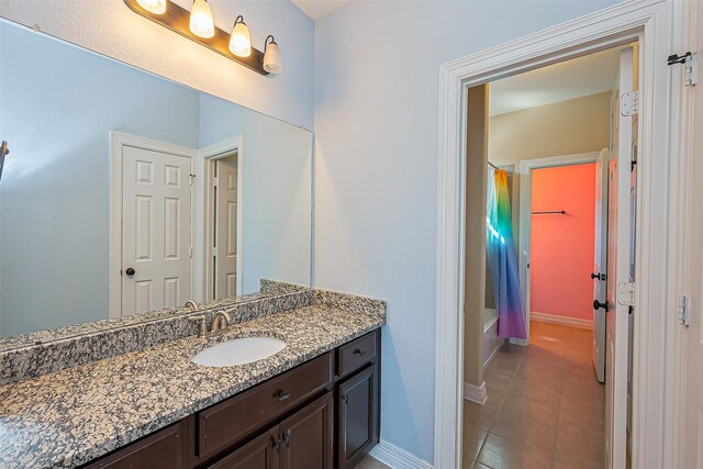10018 Durango Path Ln, Cypress, TX 77433 - bathroom with tile patterned floors, vanity, shower / tub combo with curtain, and baseboards