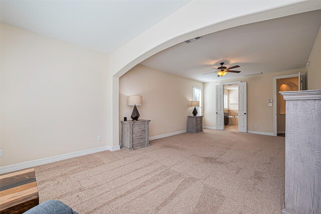 10018 Durango Path Ln, Cypress, TX 77433 - unfurnished living room featuring carpet flooring, a ceiling fan, baseboards, and arched walkways