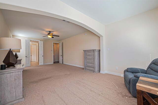 10018 Durango Path Ln, Cypress, TX 77433 - living room featuring arched walkways, light colored carpet, visible vents, and ceiling fan