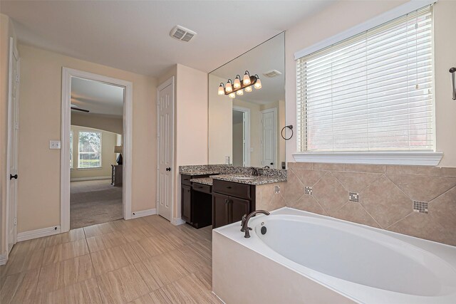 10018 Durango Path Ln, Cypress, TX 77433 - full bath with vanity, a bath, baseboards, and visible vents