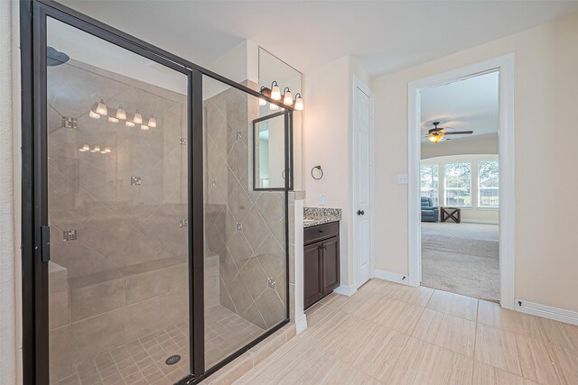 10018 Durango Path Ln, Cypress, TX 77433 - bathroom with baseboards, a shower stall, vanity, and a ceiling fan
