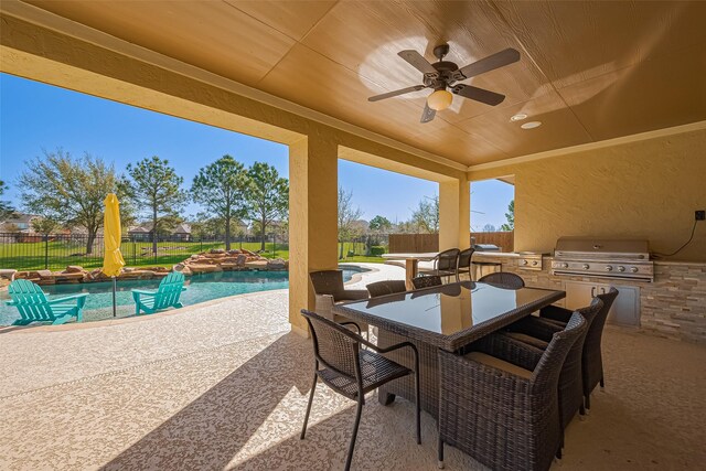 10018 Durango Path Ln, Cypress, TX 77433 - view of patio / terrace with grilling area, a fenced backyard, an outdoor kitchen, and outdoor dining space