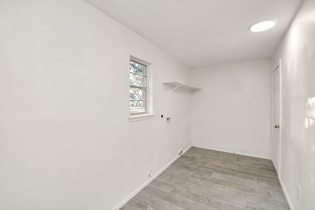 washroom featuring light wood finished floors, baseboards, washer hookup, laundry area, and hookup for a gas dryer