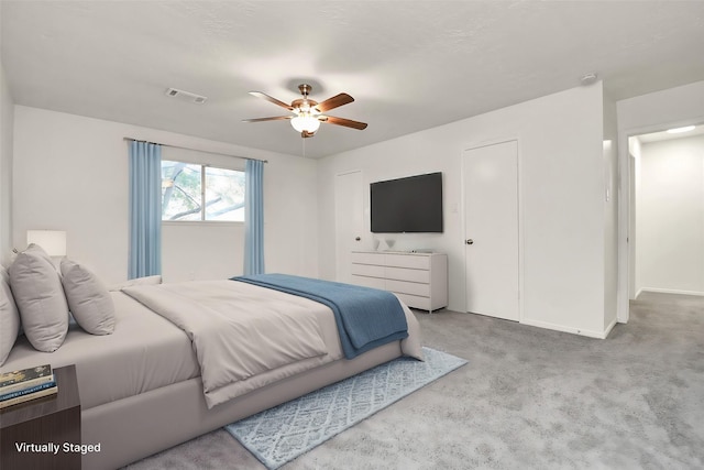 bedroom with baseboards, carpet, visible vents, and ceiling fan