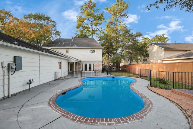 view of swimming pool with a fenced in pool, french doors, a fenced backyard, and a patio