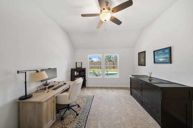 office space with light carpet, baseboards, ceiling fan, and vaulted ceiling