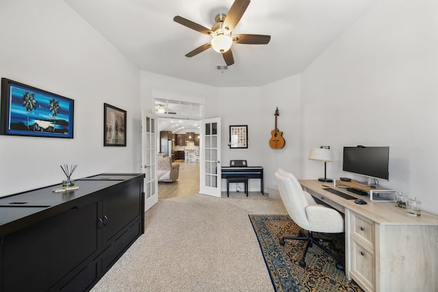 office with a ceiling fan, french doors, visible vents, and light carpet