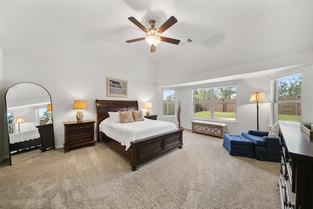 bedroom with baseboards, light colored carpet, visible vents, and ceiling fan