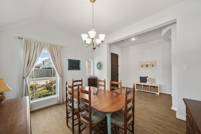 dining room with an inviting chandelier, wood finished floors, and baseboards