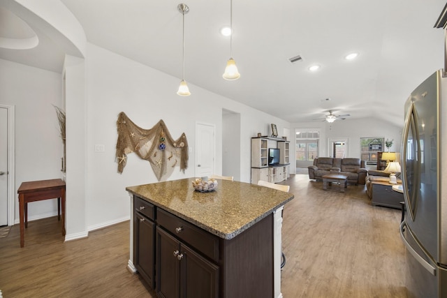 kitchen with visible vents, light wood-style flooring, freestanding refrigerator, and ceiling fan