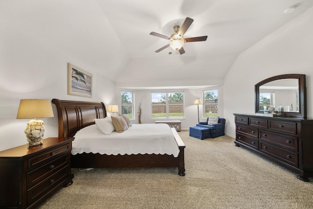 bedroom featuring baseboards, light colored carpet, a ceiling fan, and vaulted ceiling