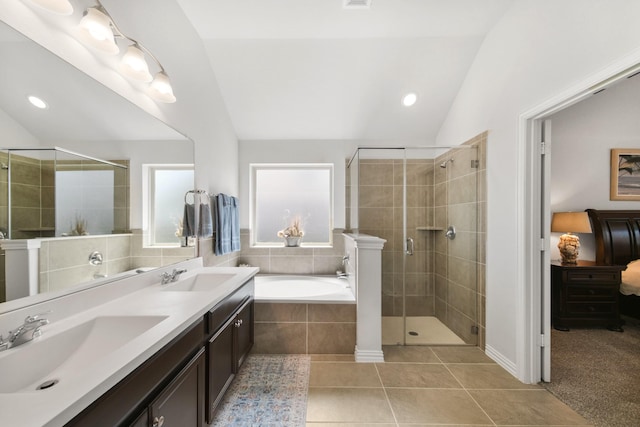 full bath featuring a sink, lofted ceiling, a shower stall, and tile patterned flooring