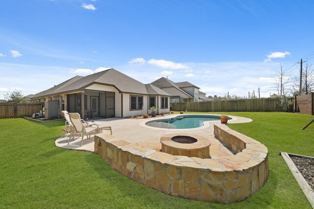 view of swimming pool featuring a patio, a yard, and a fenced backyard