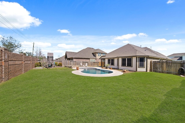 view of yard with a fenced in pool, a playground, and a fenced backyard