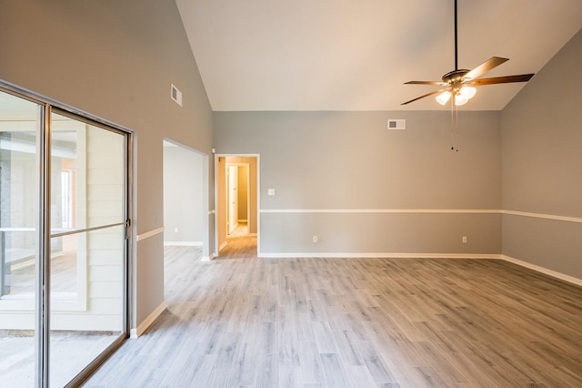 spare room featuring visible vents, plenty of natural light, light wood-type flooring, and baseboards