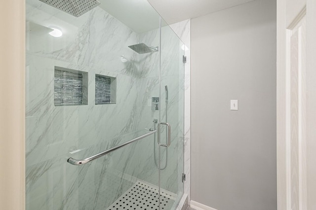 bathroom featuring a marble finish shower and baseboards