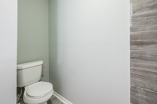 bathroom featuring toilet and baseboards