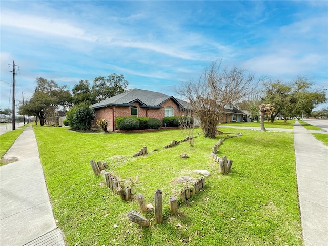 view of front of home with brick siding and a front yard